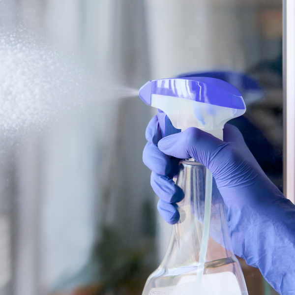 cleaning fluid is sprayed onto a glass pane from an atomizer cleaning fluid is sprayed onto a glass pane from an atomizer